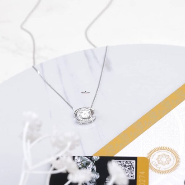 0.50ct Moissanite Love Duo necklace in 925 Sterling Silver on a glass table