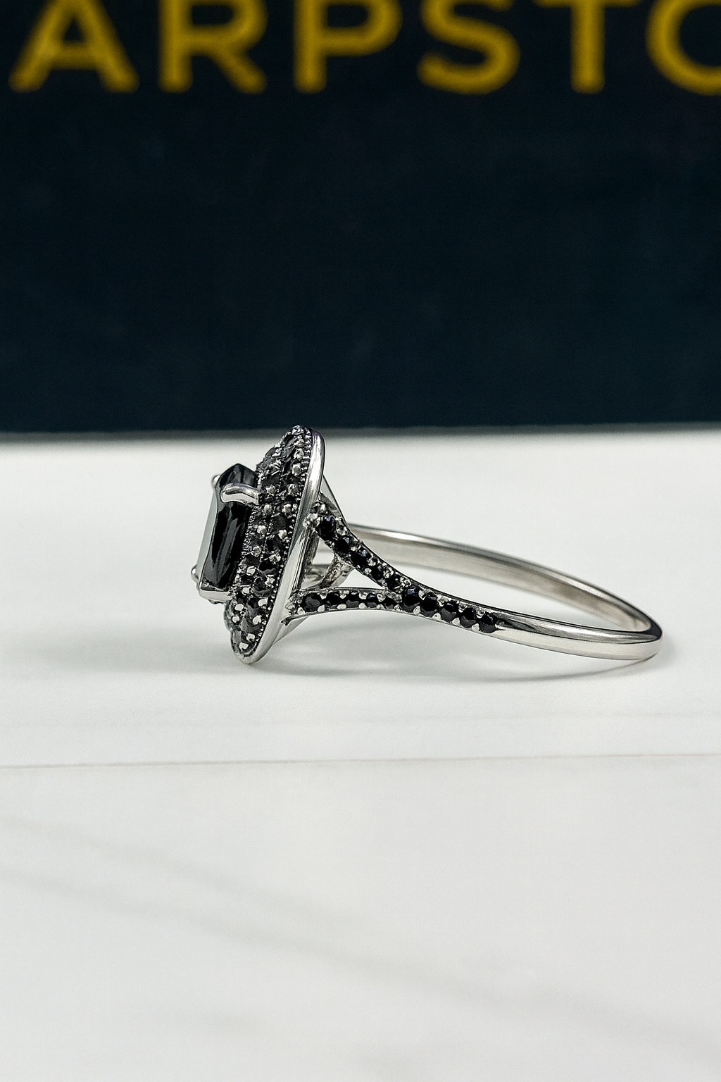 Quinn black engagement ring with moissanite stones side view.png