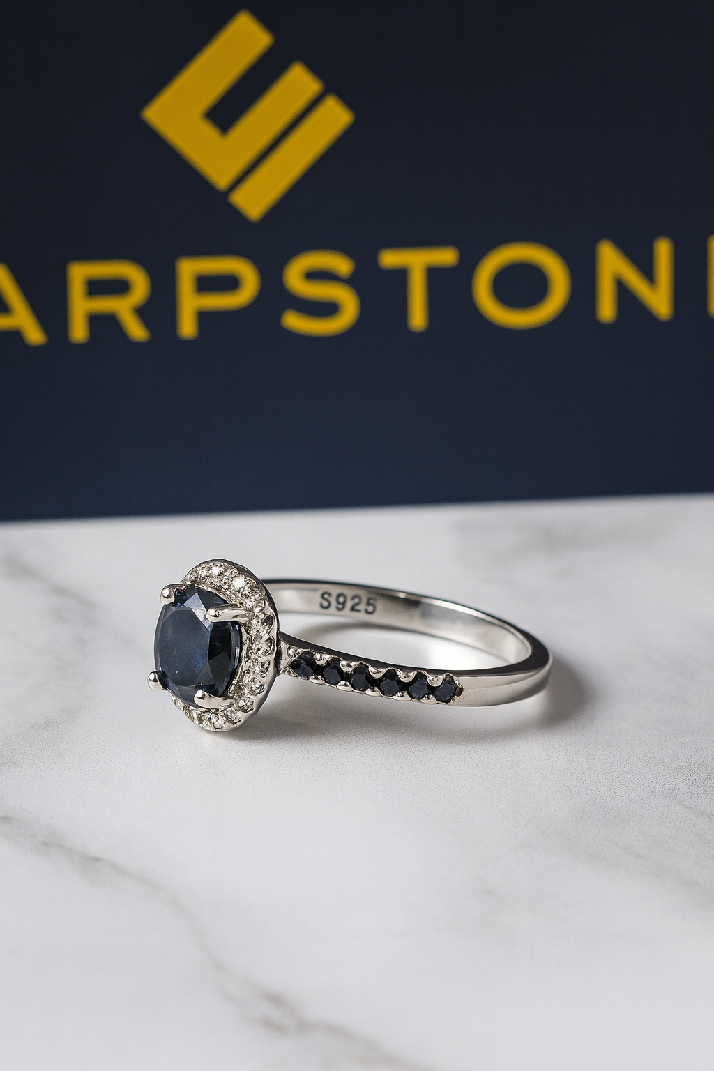 Spa black engagement ring with moissanite stones side view.png